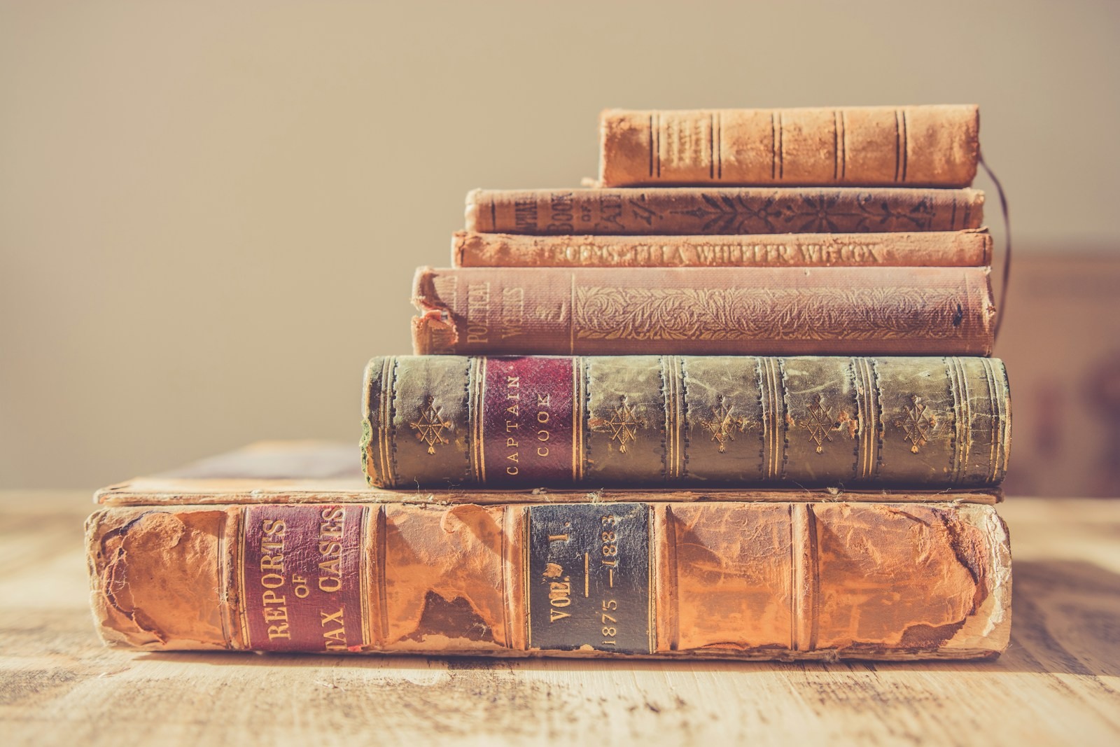 A stack of older bound books seen at shallow focus