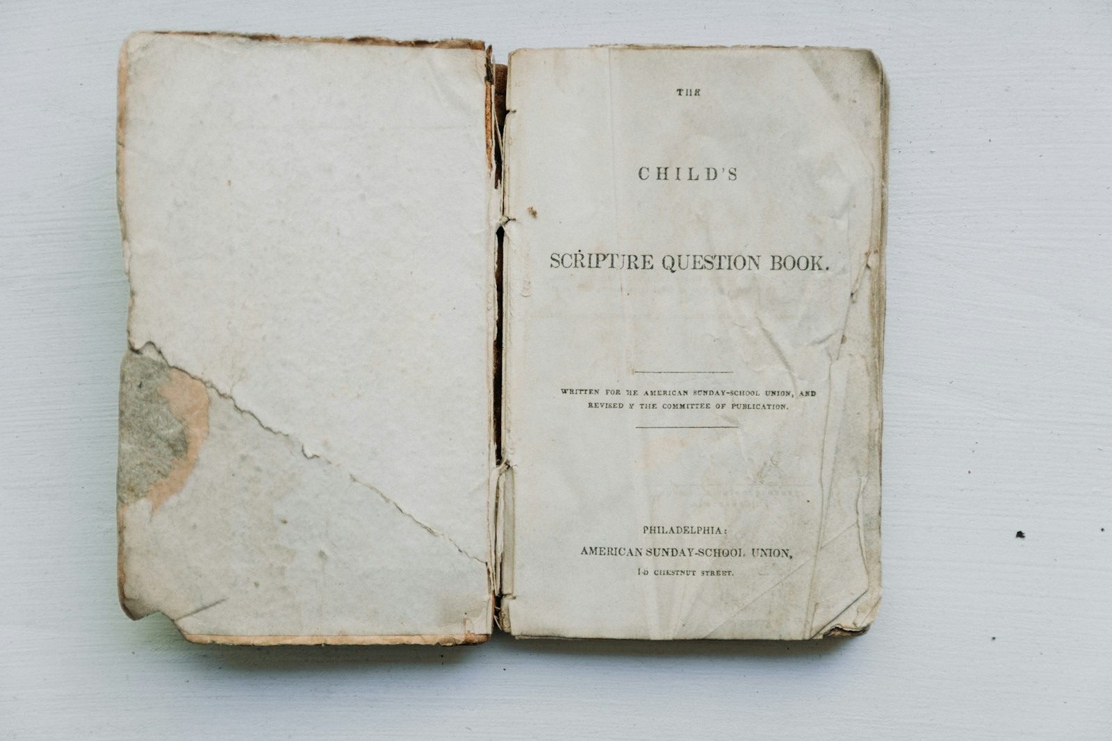 An old book lying open on a pale surface